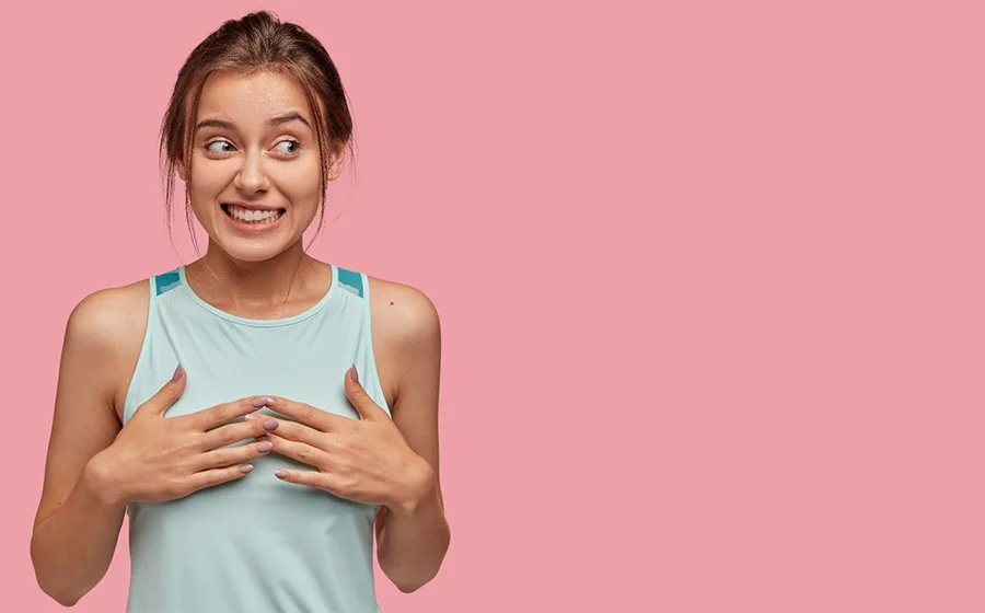 Young woman thinking about different breast implant types and longevity for augmentation in Bangalore
