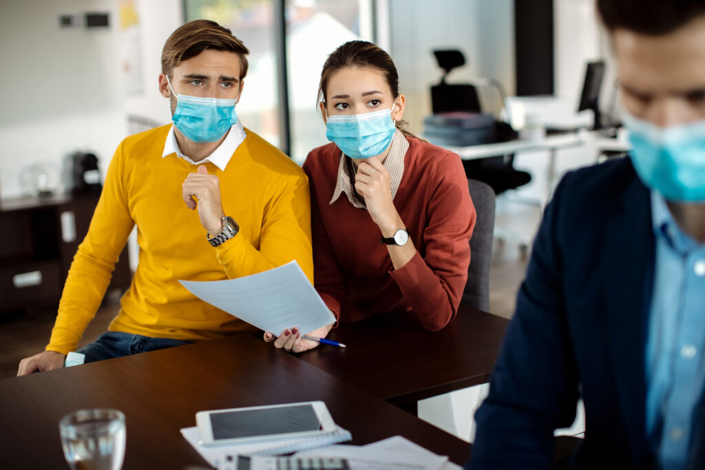 distraught couple analyzing paperwork while having meeting with bank manager coronavirus pandemic.jpg