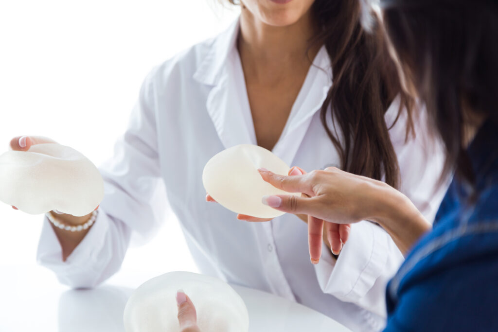 doctor her patient choosing mammary prosthesis office