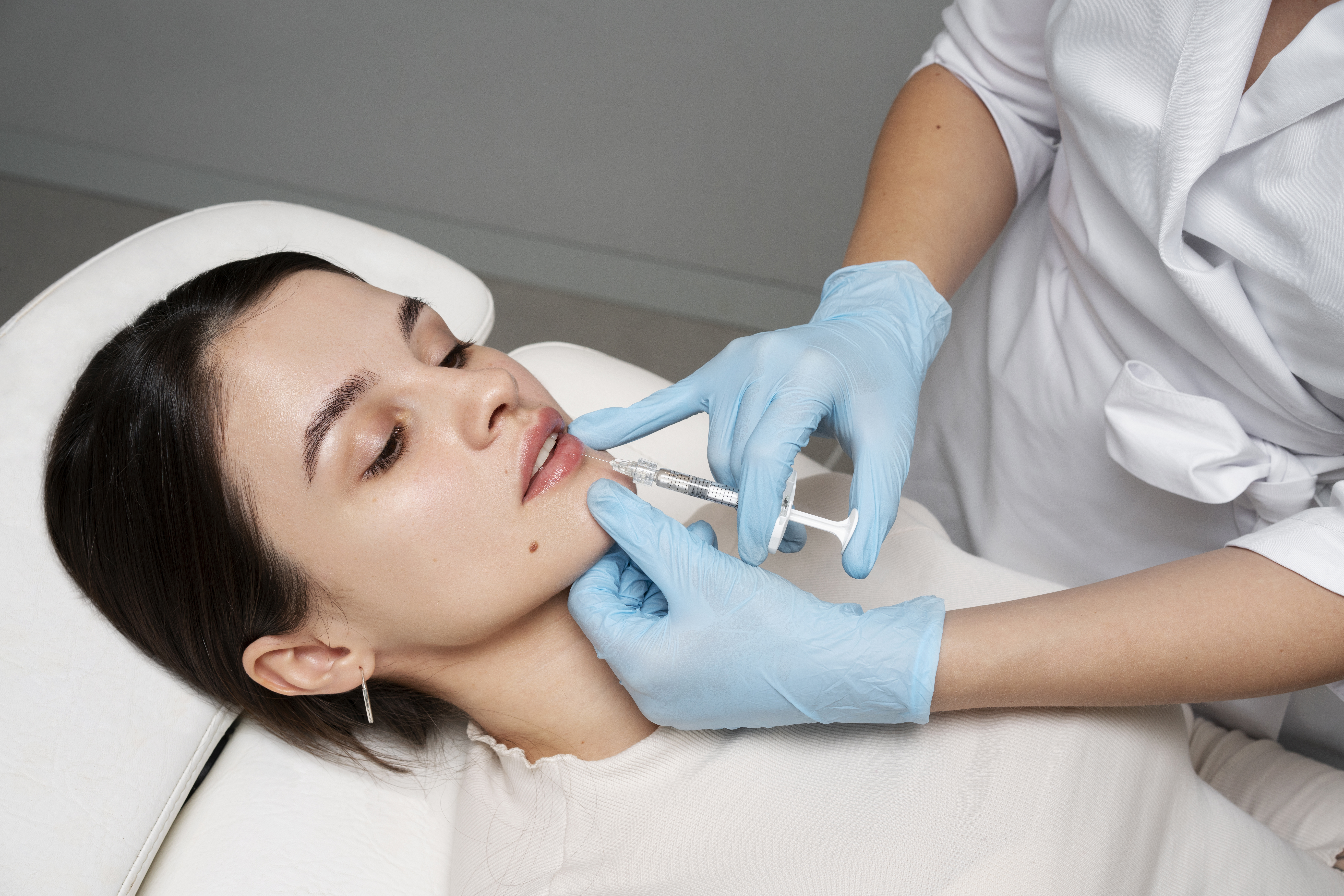 doctor s hands giving lip fillers 1