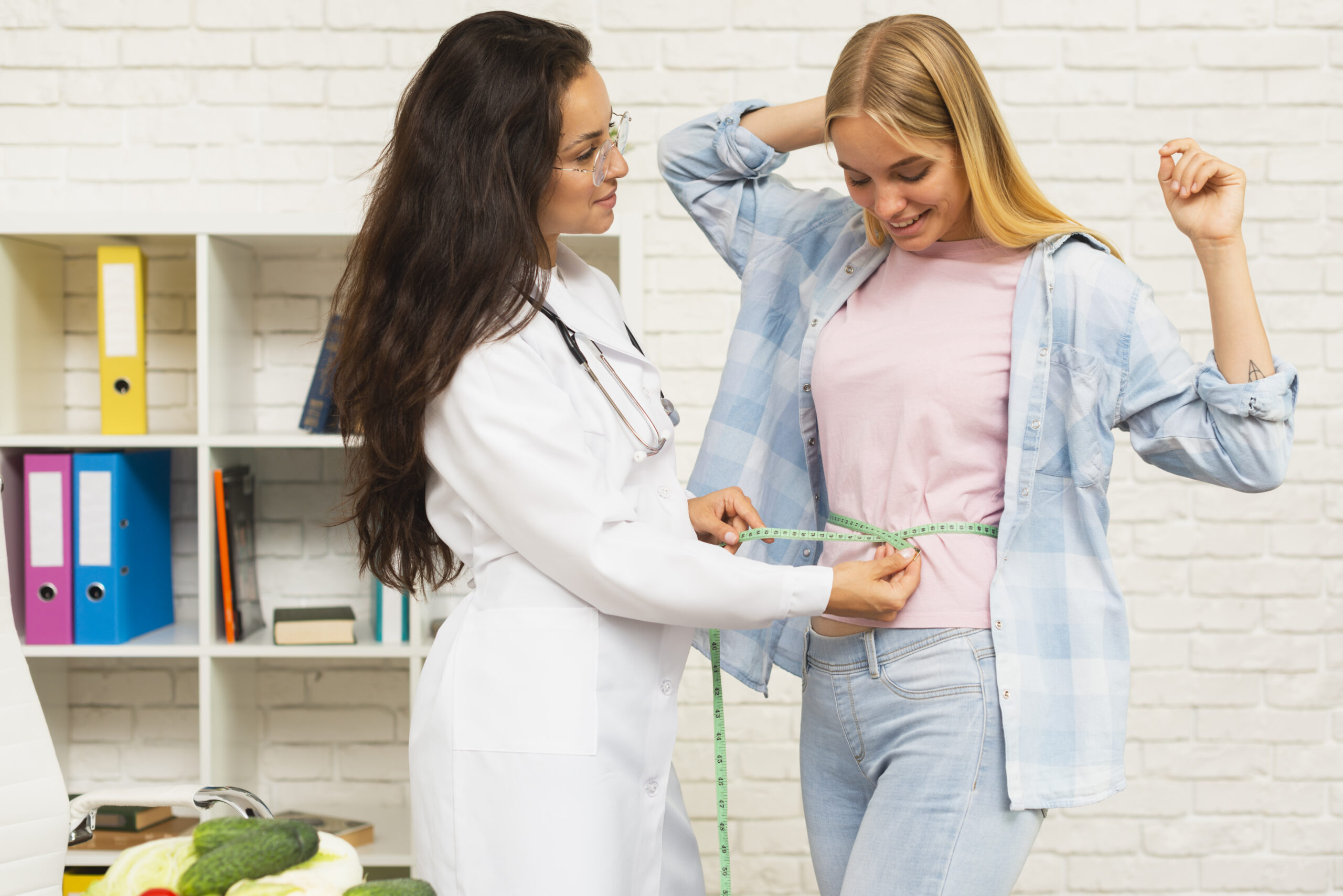 medium shot nutritionist measuring her patient scaled