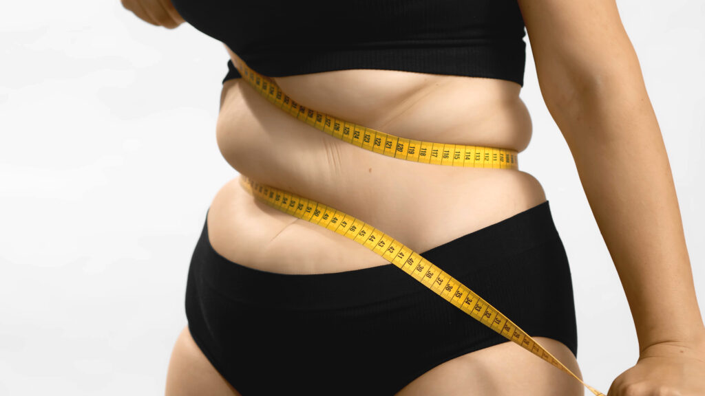obesity problems plus size female hate her body beauty standards bands centimeter measuring tape insecure needs healthy weight loss diet anonymous medium studio shot photo white background