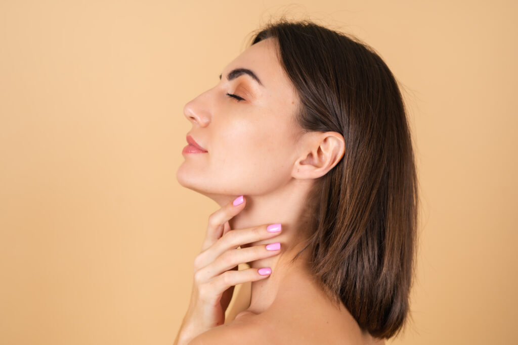 Kybella vs Liposuction: Which Works Better for Double Chin? 1 portrait young woman beige with natural makeup with light sensual smile bare shoulders beauty face advertising cosmetics care