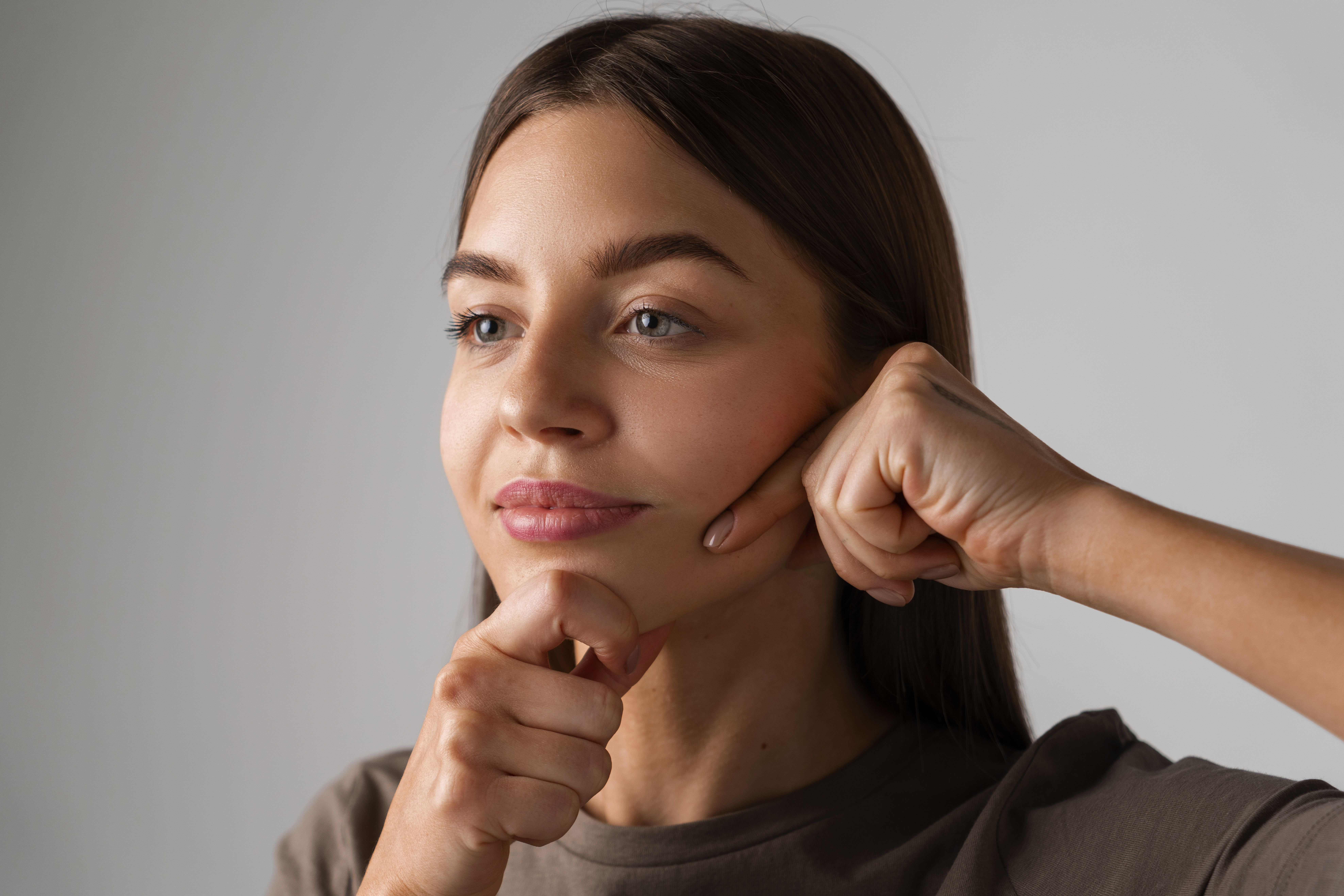 Do Cheek Implants Look Natural? What to Expect | Expert Guide to Natural-Looking Cheek Augmentation in Bangalore 2 portrait young woman practicing facial yoga youth